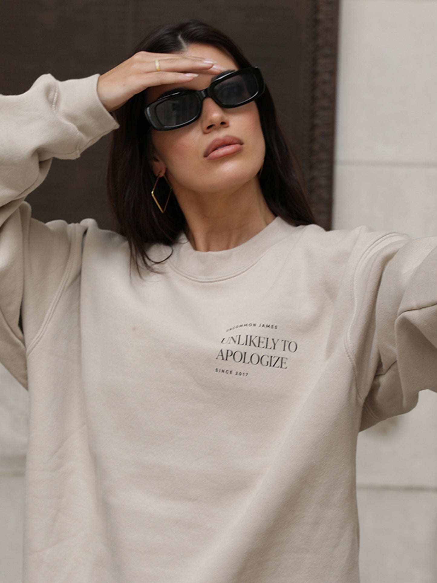 Unlikely to Apologize Sweatshirt | Beige | Model Image | Uncommon James