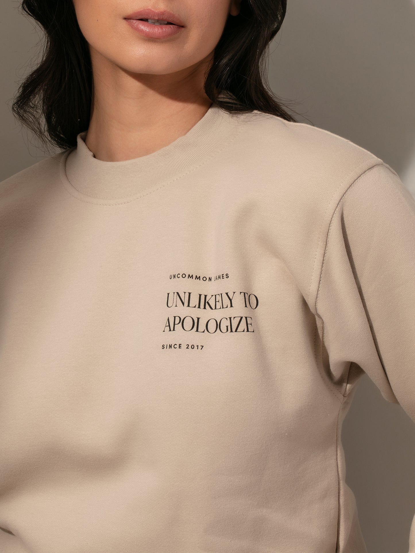 Unlikely to Apologize Sweatshirt | Beige | Model Image 2 | Uncommon James
