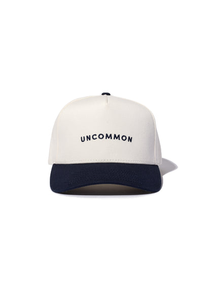 ["Simple Uncommon Trucker Hat ", " Navy/Cream ", " Product Image ", " Uncommon Lifestyle"]