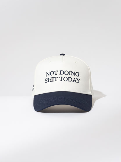 ["Day Off Trucker Hat ", " White and Navy ", " Product Image ", " Uncommon Lifestyle "]