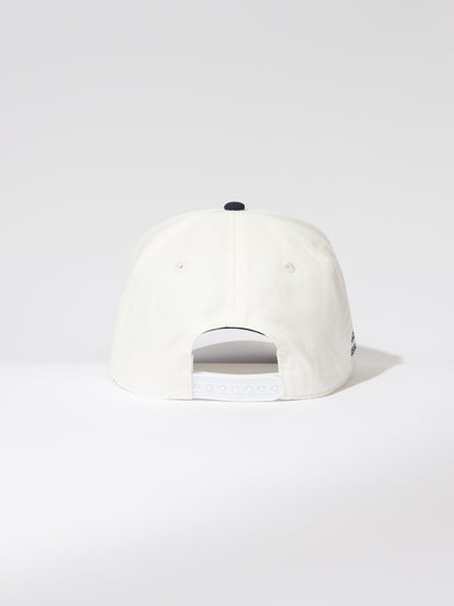 ["Day Off Trucker Hat ", " White and Navy ", " Product Image ", " Uncommon Lifestyle "]