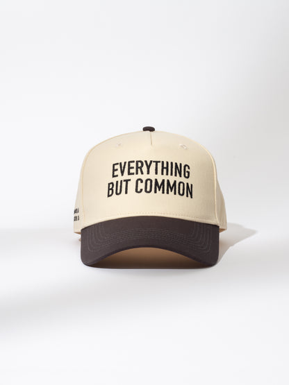 ["Everything But Common Trucker Hat ", " Ivory and Black ", " Product Image ", " Uncommon Lifestyle"]