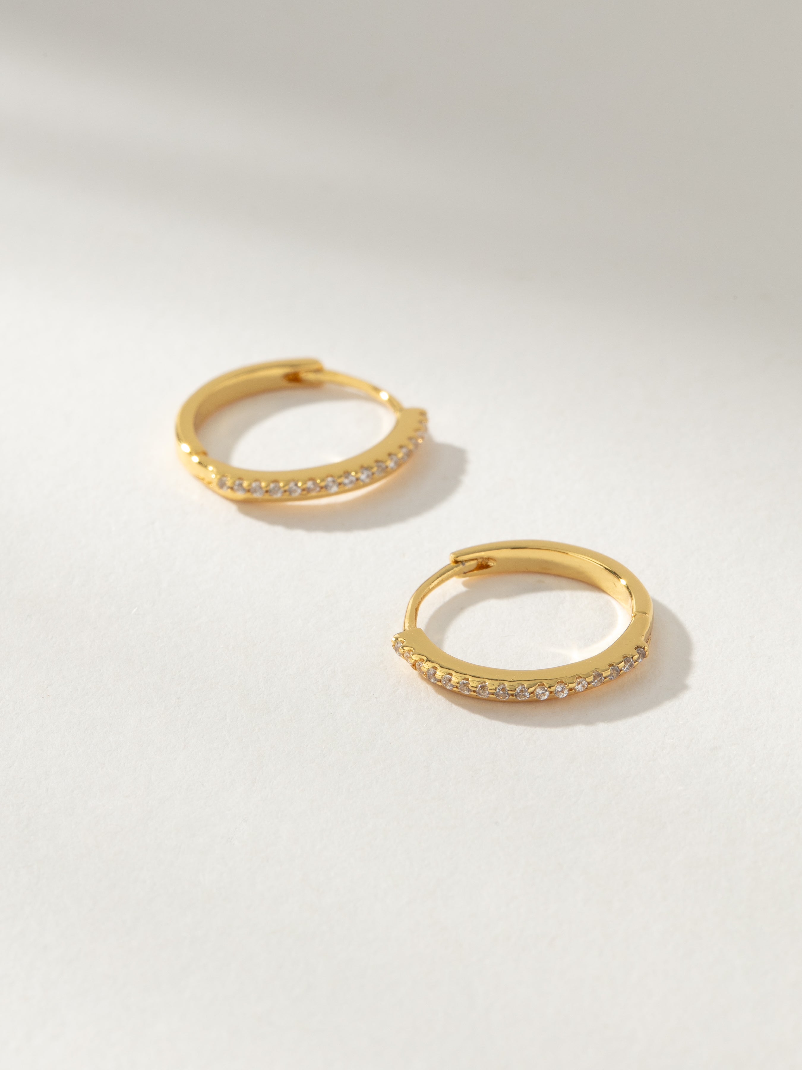 Innocent Pavé Huggie Hoop Earrings in Gold | Uncommon James