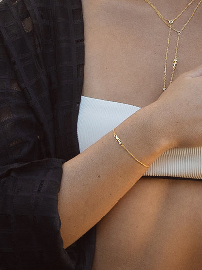 ["Fish Bone Chain Bracelet ", " Gold ", " Model Image 2 ", " Uncommon James"]