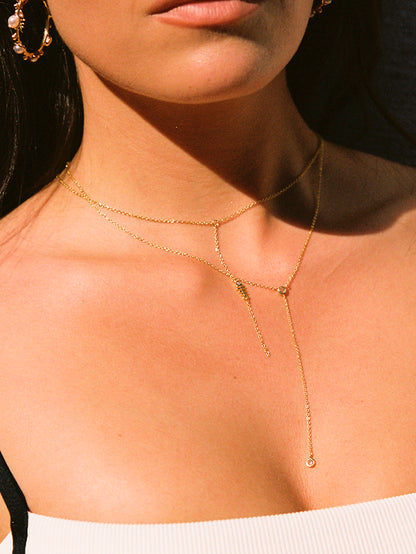 ["Fish Bone Lariat Necklace ", " Gold ", " Model Image 2 ", " Uncommon James"]