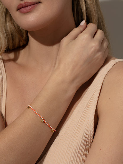 ["Sunset Beaded Bracelet ", " Gold Orange/White ", " Model Image ", " Uncommon James"]