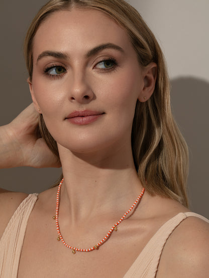 ["Sunset Beaded Necklace ", " Gold Orange/White ", " Model Image ", " Uncommon James"]