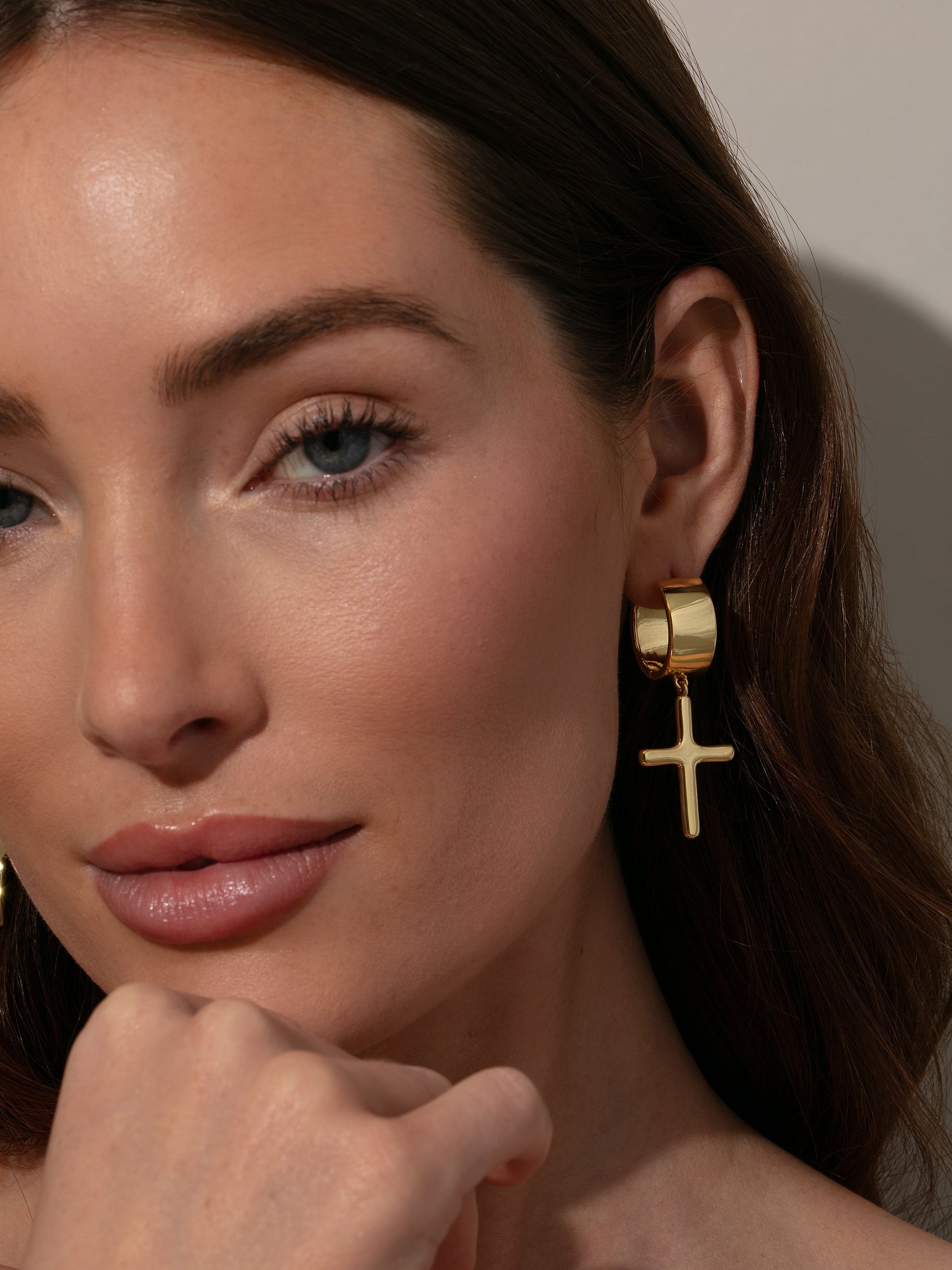 Chunky Cross Huggie Earrings | Gold | Model Image | Uncommon James