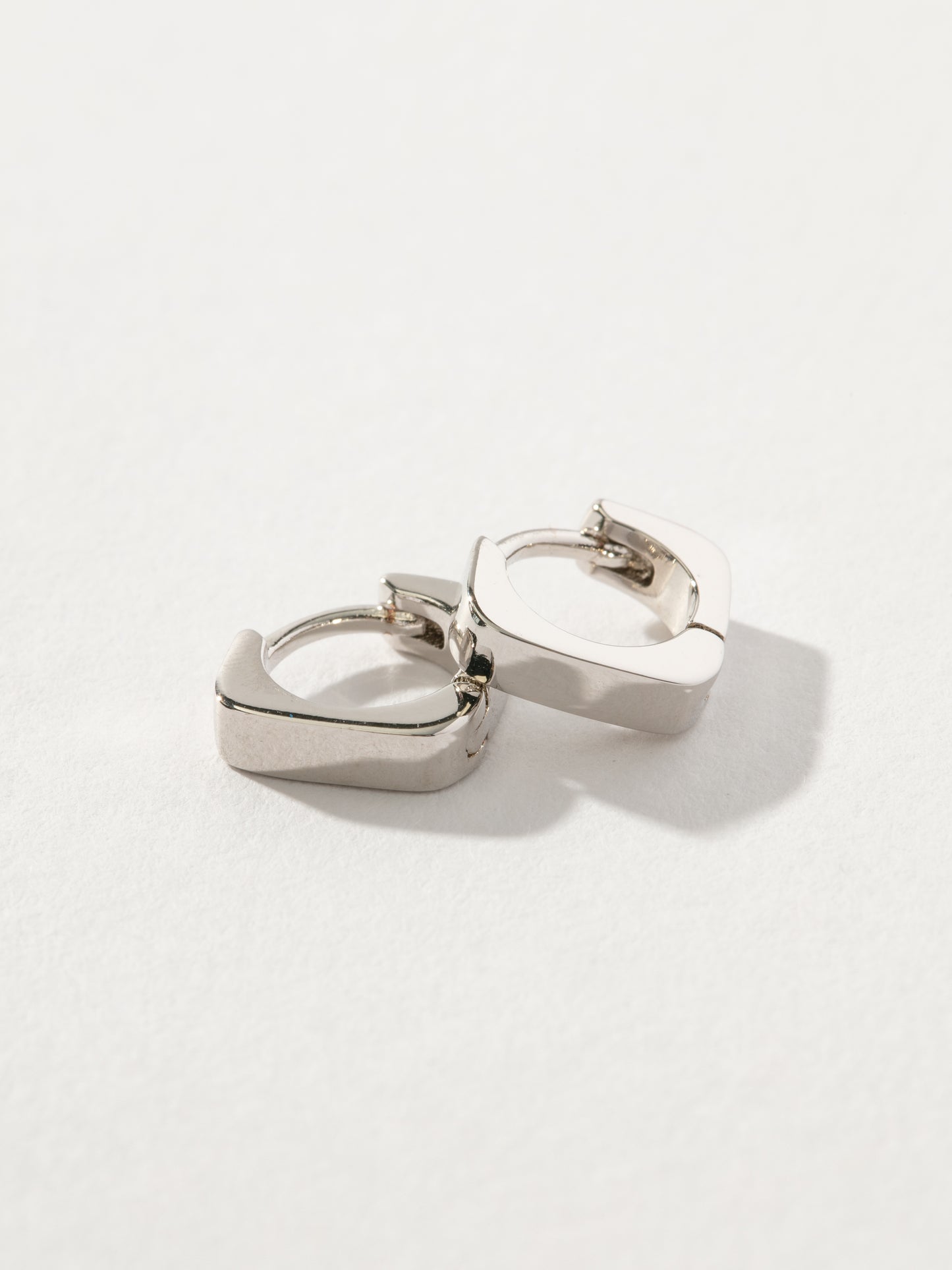 Money Maker Huggie Earrings | Silver | Product Detail Image | Uncommon James