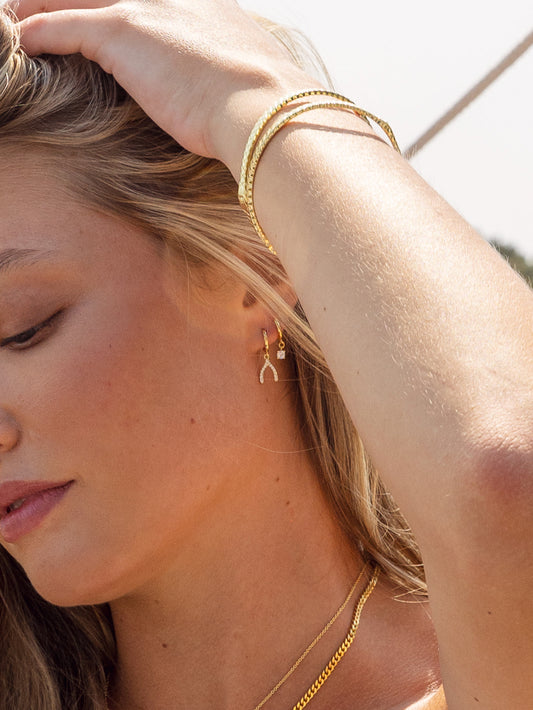 Pavé Wishbone Drop Huggie Earrings | Gold | Lifestyle Image | Uncommon James