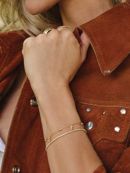 ["Higher Shine Cross and Chain Bracelet ", " Gold ", " Campaign Image ", " Uncommon James"]