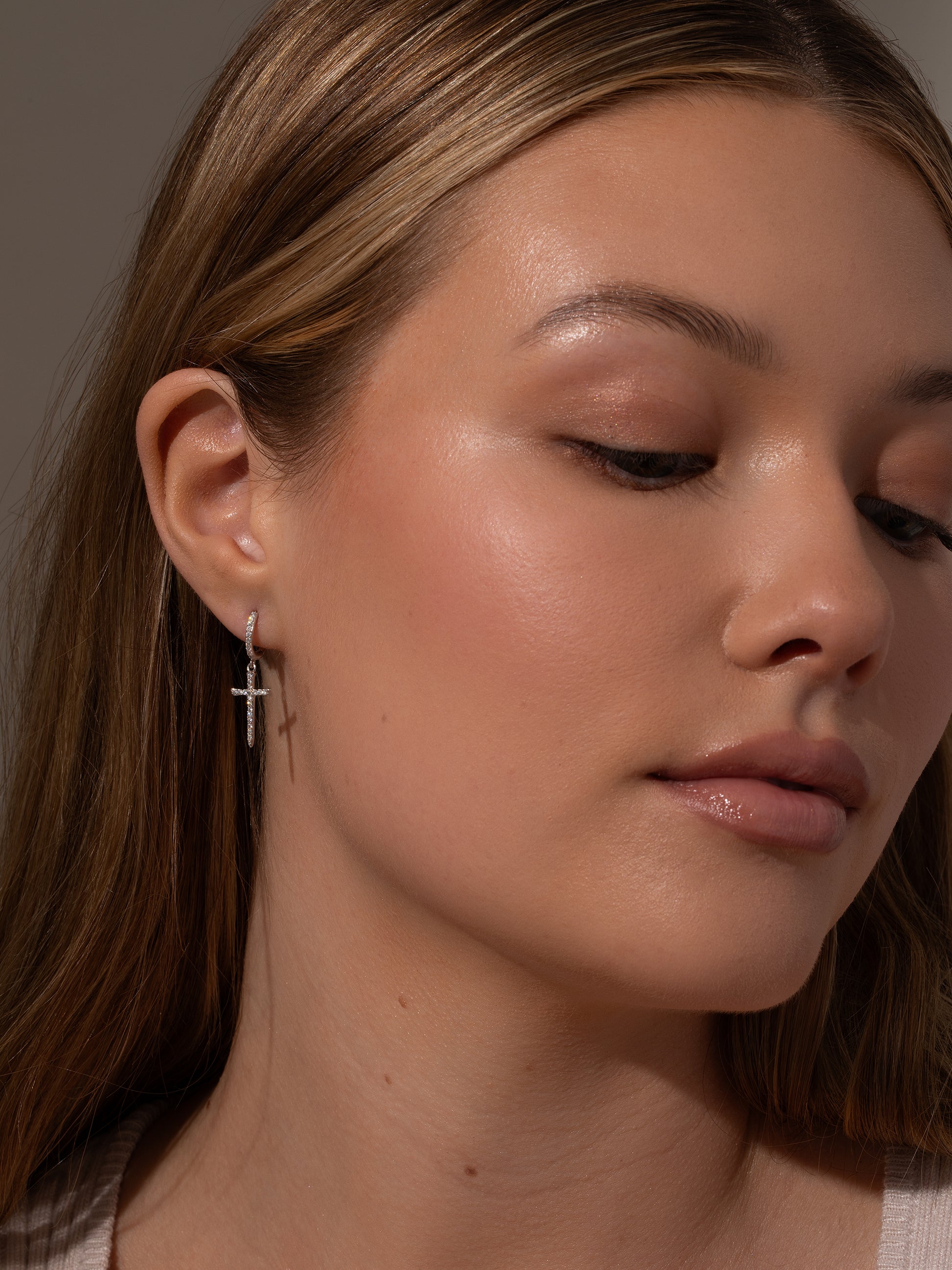 Higher Shine Cross Huggie Earrings | Silver | Model Image | Uncommon James