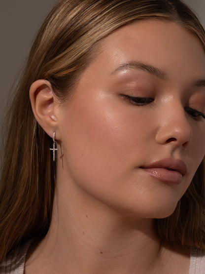 ["Higher Shine Cross Huggie Earrings ", " Silver ", " Model Image ", " Uncommon James"]