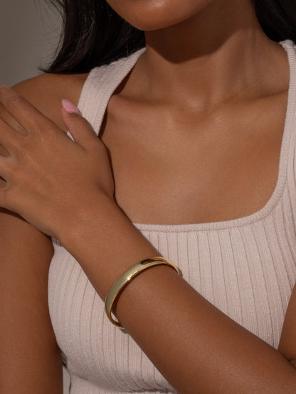 ["Take a Hint Statement Bracelet ", " Gold ", " Model Image ", " Uncommon James"]