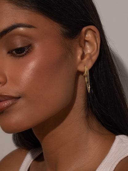 ["Cross and Chain Huggie Earrings ", " Gold ", " Model Image ", " Uncommon James"]