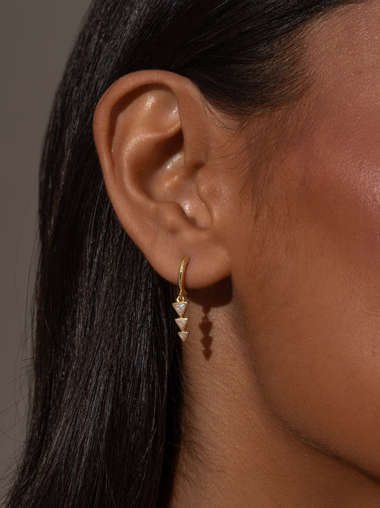 Moving On Arrow Huggie Earrings | Gold | Product Image | Uncommon James