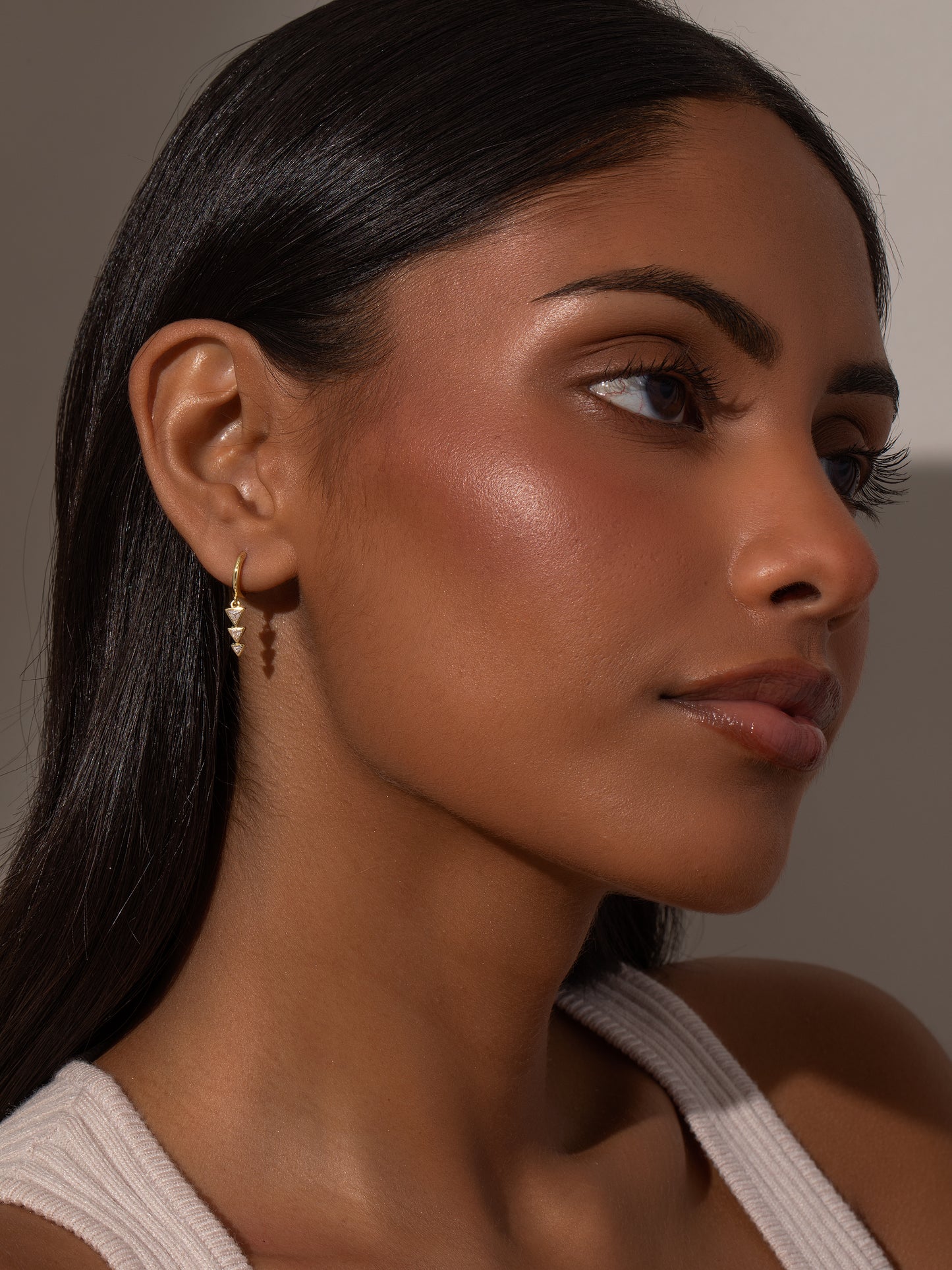 Moving On Arrow Huggie Earrings | Gold | Model Image | Uncommon James