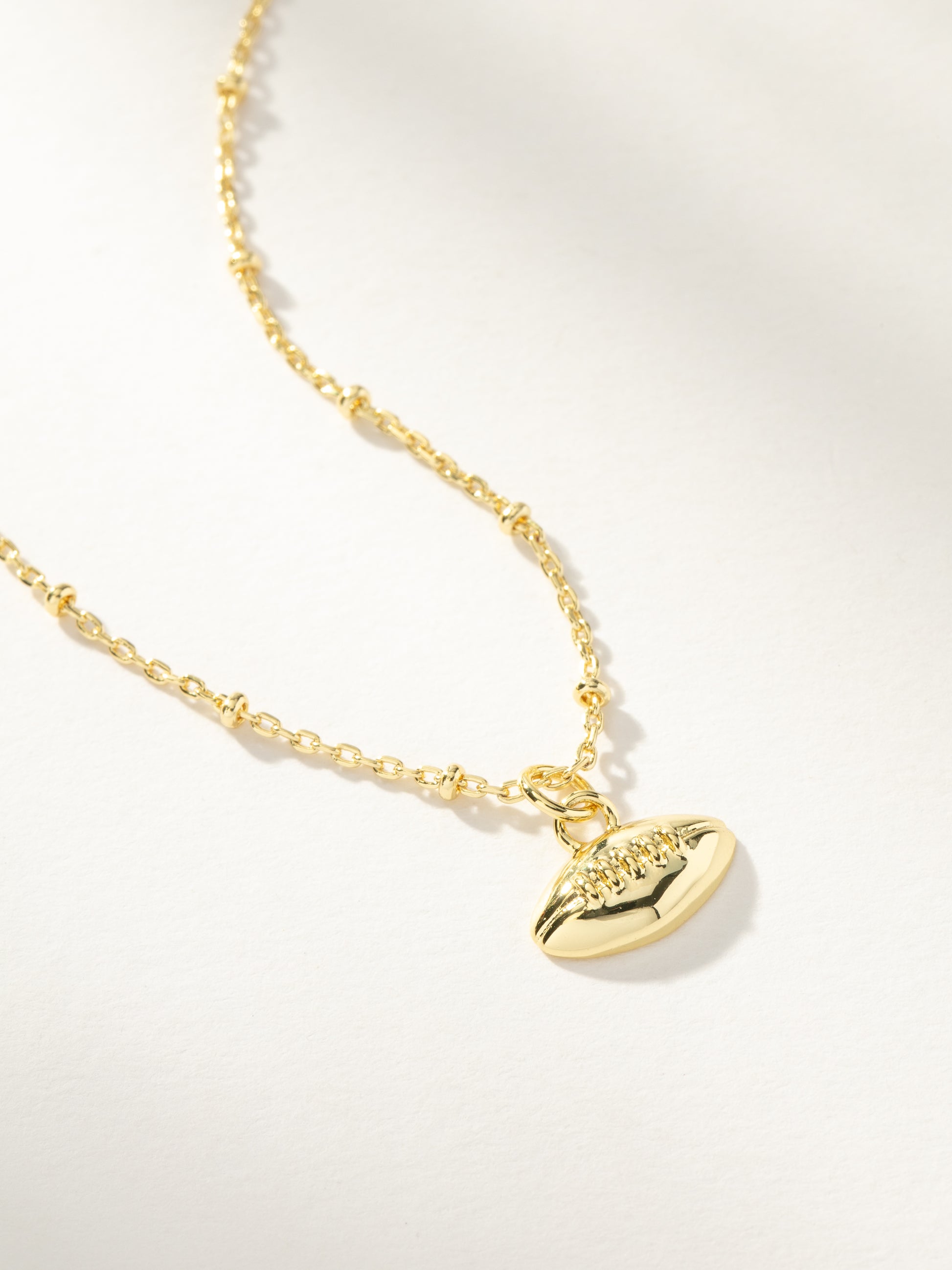 Football Pendant Necklace | Gold | Product Image | Uncommon Lifestyle