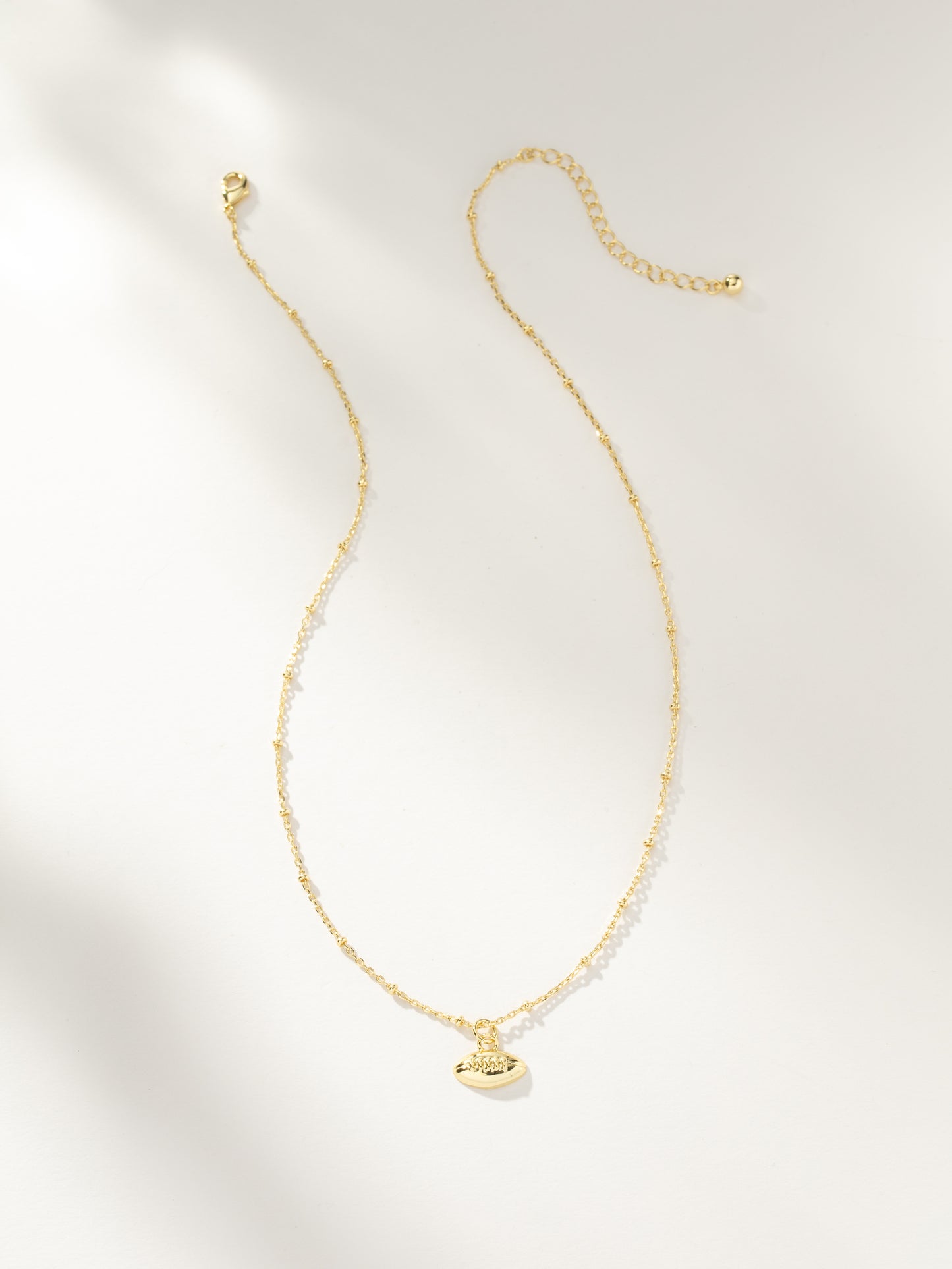 Football Pendant Necklace | Gold | Product Image | Uncommon Lifestyle