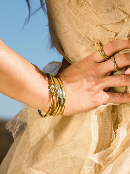 ["Forever Knot Cuff Bracelet ", " Gold ", " Campaign Image ", " Uncommon James"]