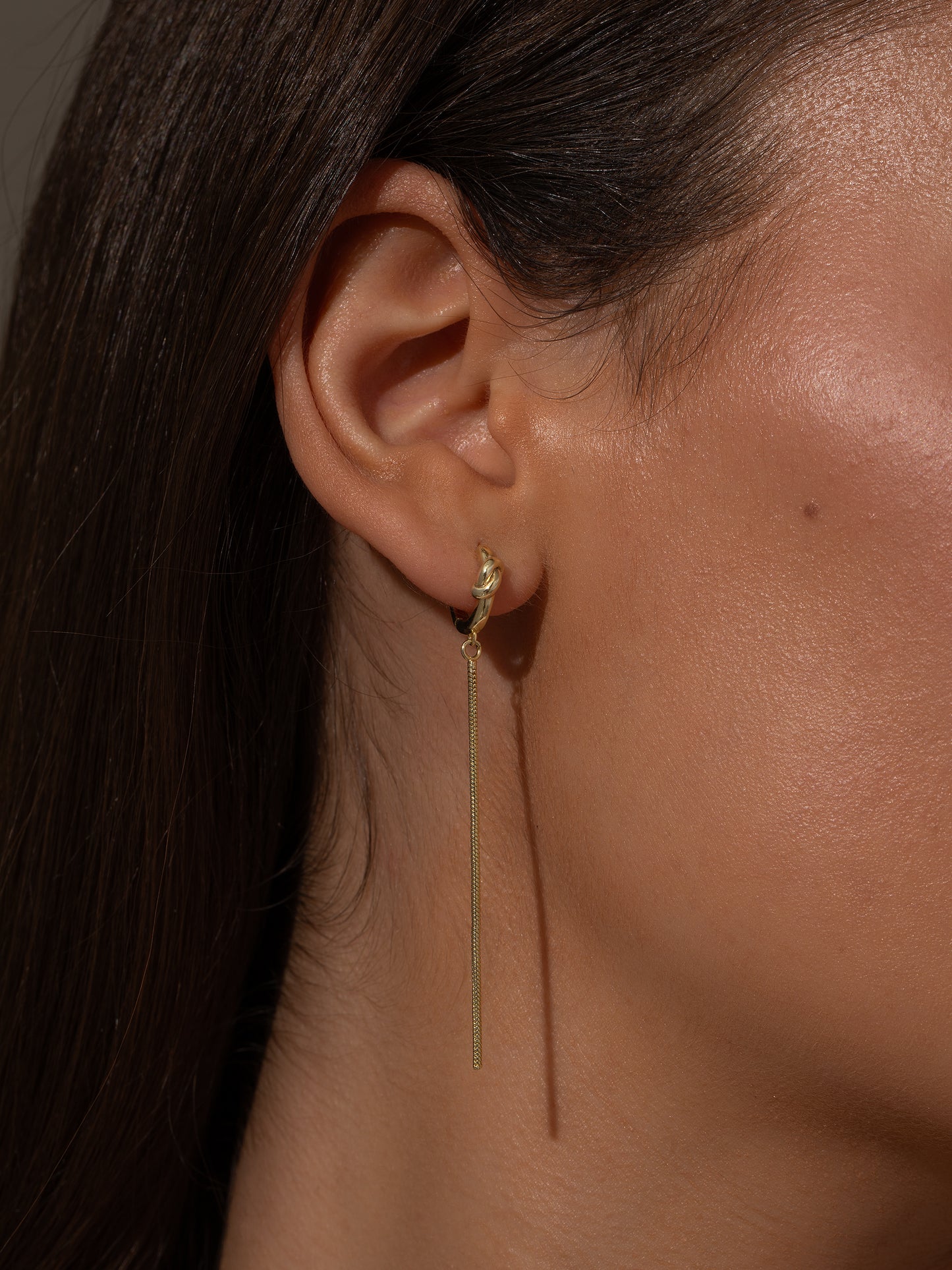 Forever Knot and Chain Huggie Earrings | Gold | Model Image | Uncommon James